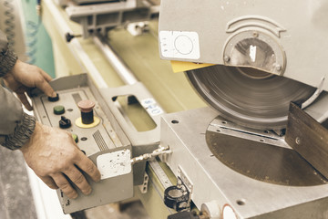 Worker Testing Circular Saw. Plastic Window and Door Industry Production.