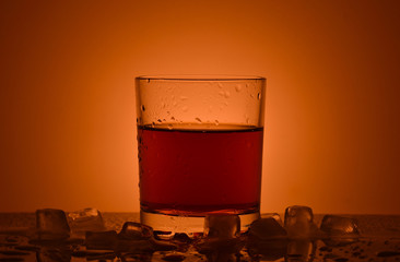 A glass of brandy with ice

