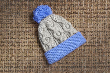 Fototapeta na wymiar Knitted cap with a pompon of wool mixture