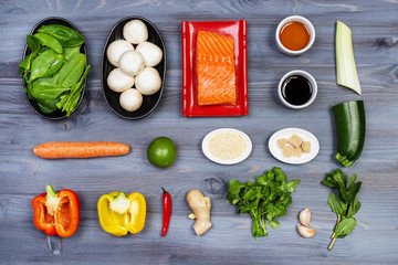 Wooden spoon and ingredients on dark background. Vegetarian food, health or cooking concept