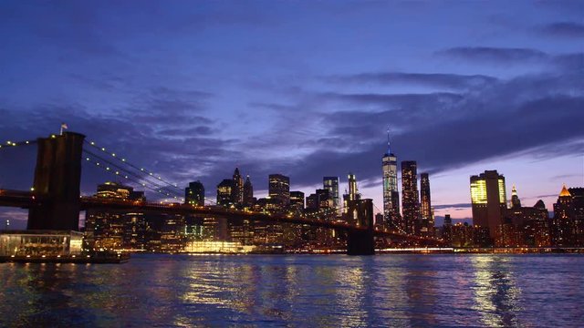 View of Brooklyn Bridge with the distinctive New York skyline in background at sunset, New York , United States