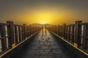 Obraz premium Walkway to meadow with sunrise.