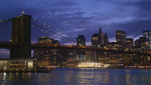 View of Brooklyn Bridge with the distinctive New York skyline in background at sunset, New York , United States