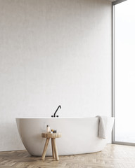 Side view of bathtub with chair and black wall