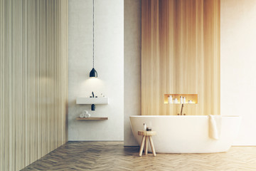 Bathtub, a sink and a chair, white walls, toned