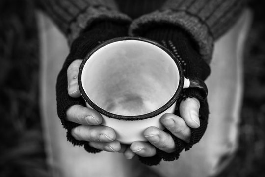 Homeless. In The Hands Of One Man Metal Bowl. In The Hands Of Black Gloves With The Fingers Cut Off.
