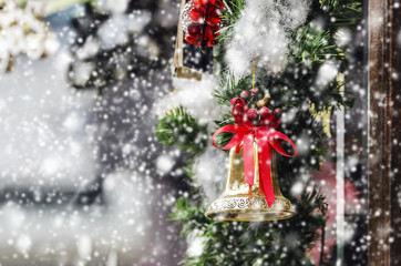 Christmas bell with red ribbon and snowy background