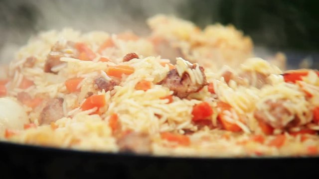 Traditional Uzbek (Middle Asia) dish is mixed during the preparation