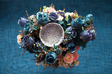 blue  flowers and  round basket on blue background,
