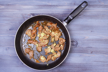 Ingredients for cooking and empty cutting board on an old wooden table. Food background with copyspace