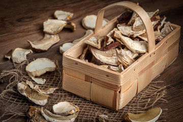 Dried mushrooms in a wooden basket.