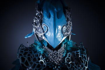 Handmade styling of a bird or mythological figure with blue wing