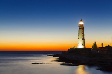 Fototapeta premium lighthouse at sunset in the twilight in clear weather