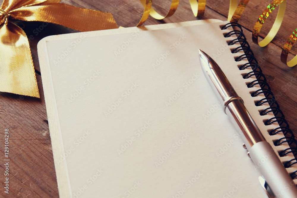 Poster top view image of open notebook with blank pages