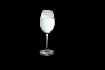 Water in glass isolated on black background