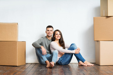 Young couple unboxing in their new home