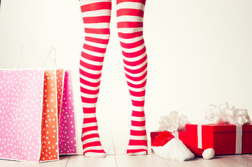 Sexy Santa woman legs. Christmas shopping concept. Xmas gift box 