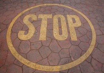 yellow stop sign painted on floor