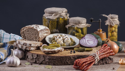 Herrings Pickles. Salted Cucumbers still-life with dark bread