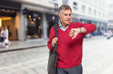 Senior man watching his wrist watch