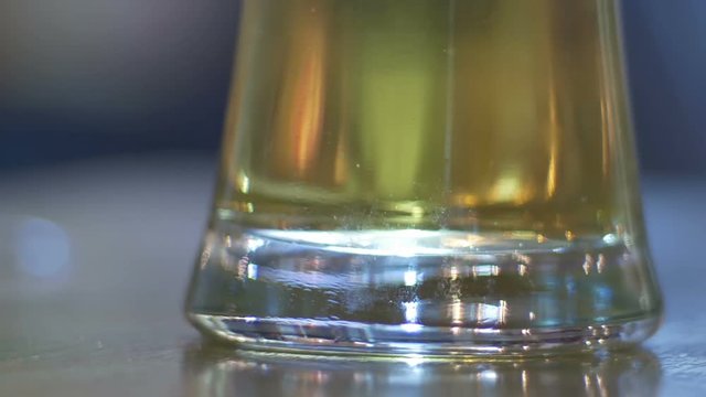 Close up of beer glass with blur background stock footage.