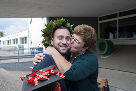 Joyous Mom Kissing Her Son After His Graduation 