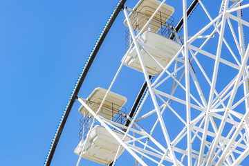 Underside view of a ferris wheel rotating downward