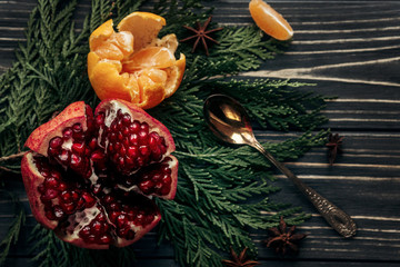 stylish rustic winter flat lay with garnet oranges and spices on