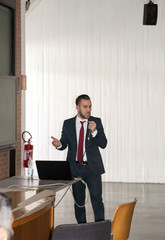 Young man during the dissertation for his doctorate