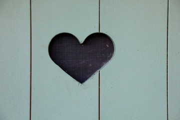 Blue wooden door with a heart in the middle
