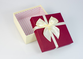 Red gift box with white ribbon isolated on white background