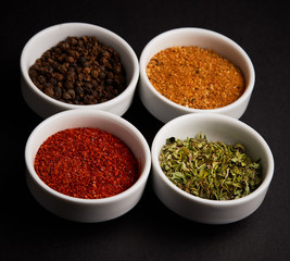 spices, seasonings on black background
