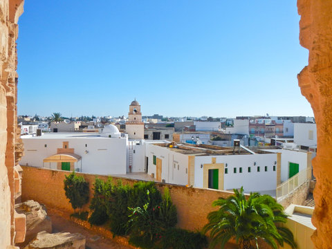El Jem city view with mosque and tunisian white houses