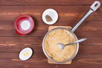 Wooden spoon and ingredients on dark background. Vegetarian food, health or cooking concept