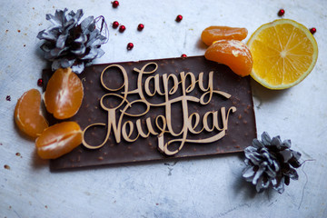 Wooden inscription Happy New Year is around the dinner table cho