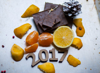 Wooden figures 2017 are on the table, along with fruit