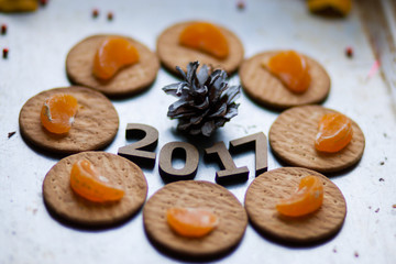 Wooden figures of 2017 are on the table, along with fruit and bi
