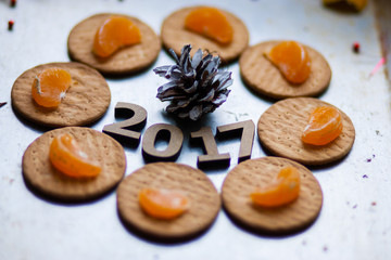 Wooden figures of 2017 are on the table, along with fruit and bi