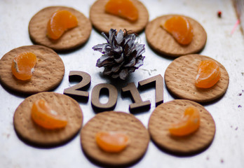 Wooden figures of 2017 are on the table, along with fruit and bi