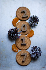 Wooden figures of 2017 are on the table, along with fruit and bi