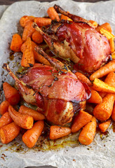 Ready to eat Roast partridges with bacon on crumpled paper.