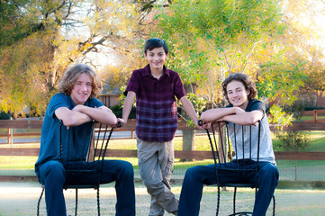 Three handsome boys posing outdoors