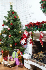 Decorated Christmas tree. Many gifts and toys under the tree for the new year. Stockings on the fireplace waiting for Santa Claus.