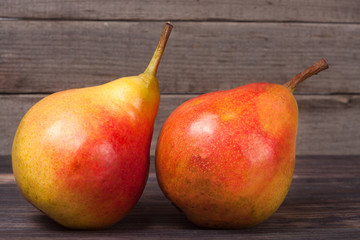 two pears on a dark wooden background