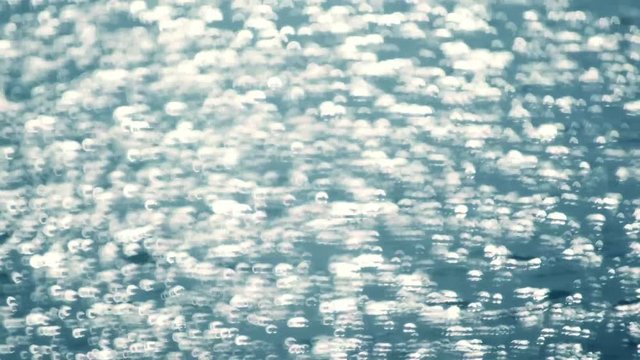 Unique shining sparkles on the blue water surface in slow motion. Awesome natural background in Full HD footage 1920x1080

