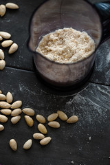 Grinding almond flour with bleached almonds in blender