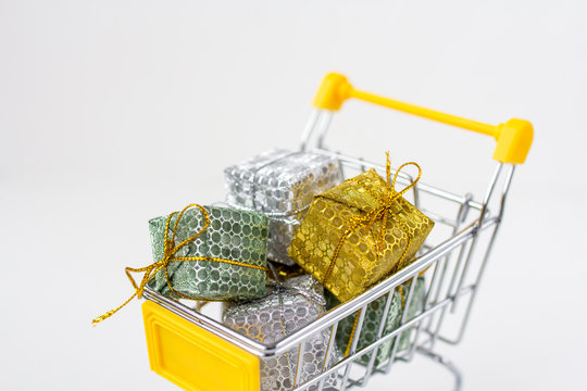 Trolley with gifts on white background