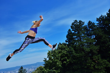 Young woman joyfully jumping in Park