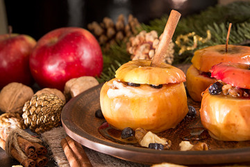 Obraz na płótnie Canvas Baked apples on brown plate with holiday Christmas decoration