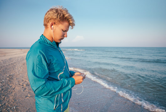 Young man prepared his musical device before run training